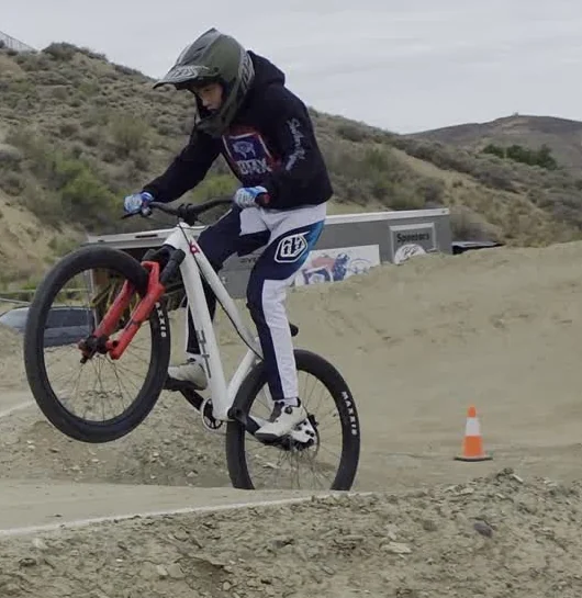 Blake rides a white dirt jumper with red forks during the Sunday Green River film